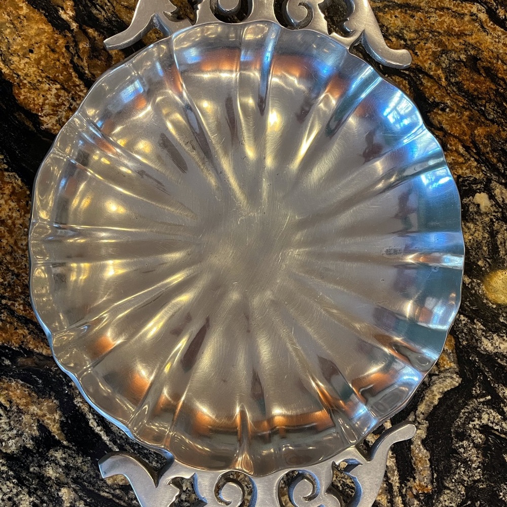 Decorative pewter bowl with beautiful handles.